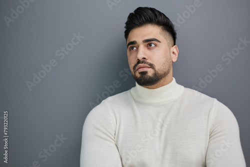 Portrait of stylish middle aged man posing on gray background