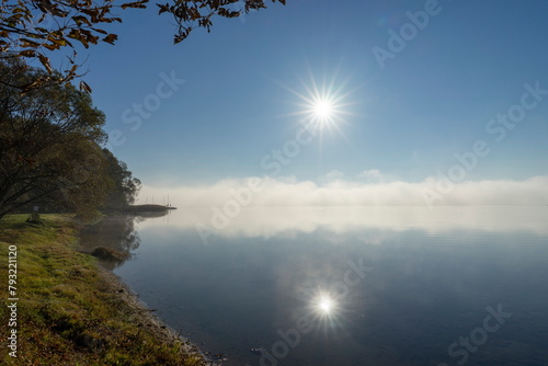 The picturesque shore of Lake Naroch on a foggy morning summer day, Belarus.