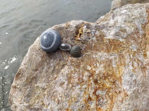 Sea pebbles - stones with patterns on the coast near the sea photo