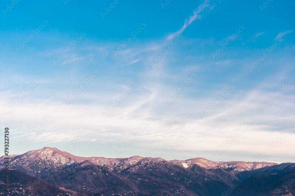 Mountains with snow-capped peaks against a blue sky. Caucasus mountains against the blue sky. Mountains with snow-capped peaks against a blue sky. Caucasus mountains against the blue sky.