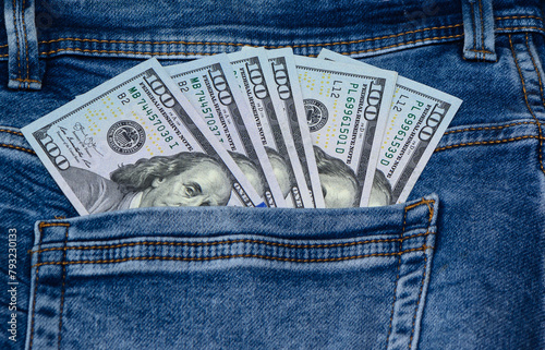 One hundred dollar banknote money in pocket jeans pants background texture. 100 dollar bill close up 1