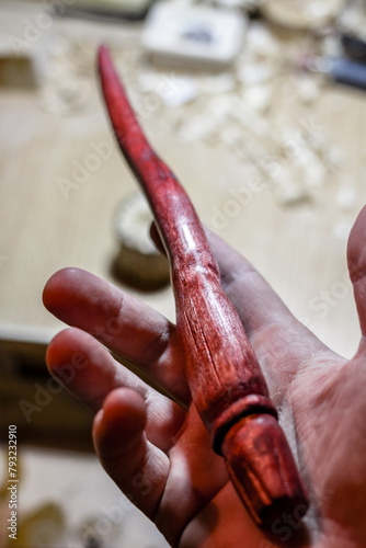 Wooden magic wand in hand  hand-crafted