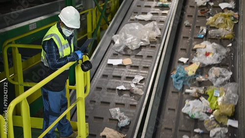 Supervisor Monitoring Conveyor Belts at Waste Management Facility