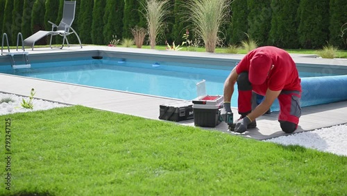 Worker Installing Outdoor Pool Decking photo