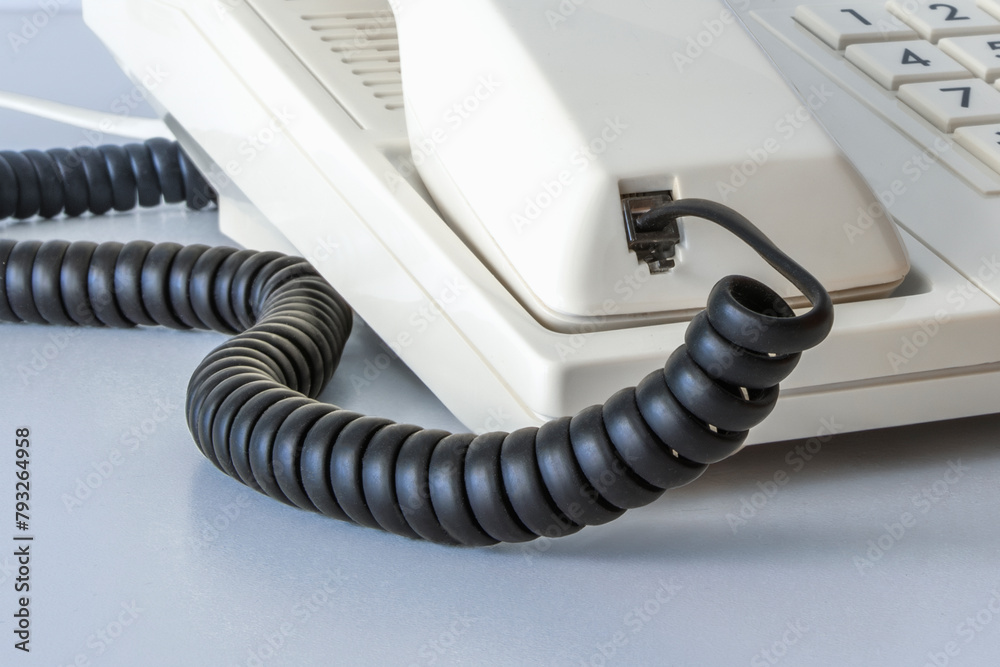 Cord and connector for a telephone set from the 80s and 90s. Close-up Cord and connector for a telephone set from the 80s and 90s. Close-up