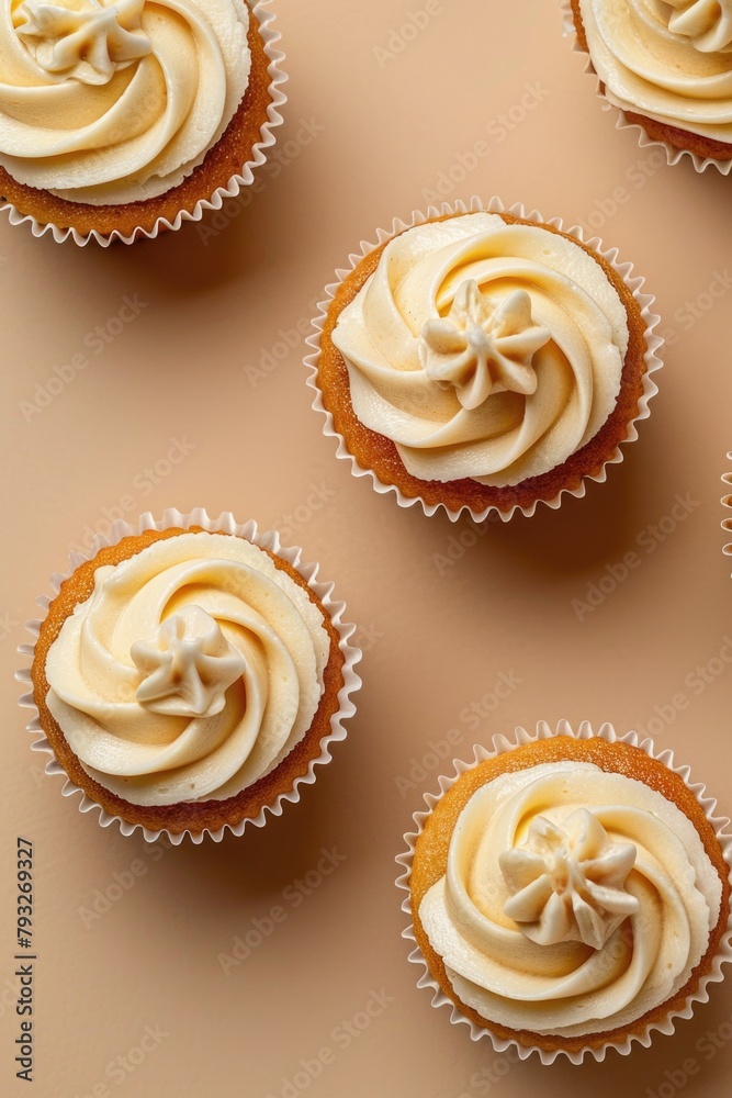Group of cupcakes with cream frosting, perfect for bakery or dessert concepts Group of cupcakes with cream frosting, perfect for bakery or dessert concepts