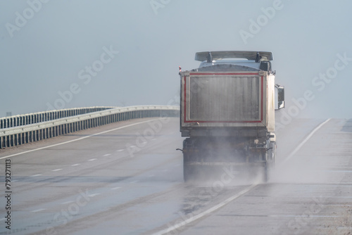 Sand lorry driving on motorway in the rain. Motorway in the rain.