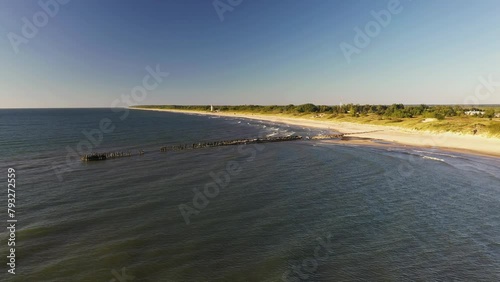 View of the long old wooden ruined pier in summer
