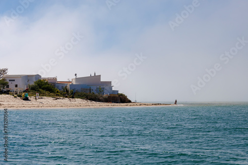 Une personne au loin sur la plage de l'ile d'Armona, région de l'Algarve au Portugal photo