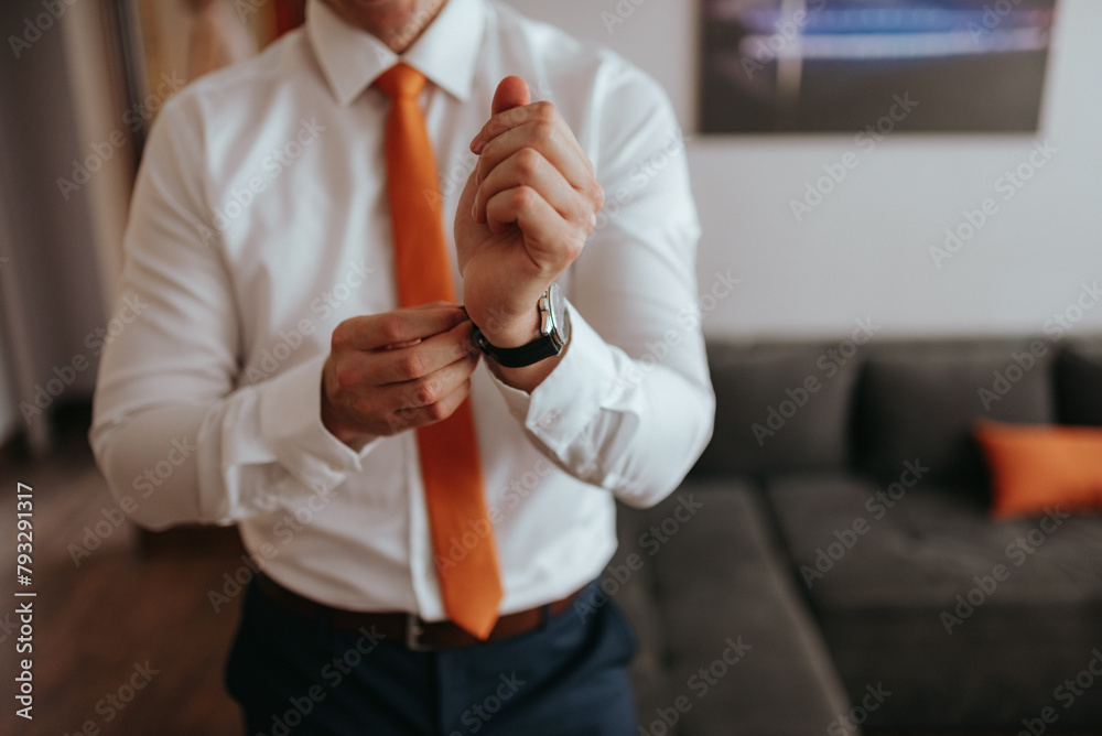 Guy is getting dressed for a business meeting.