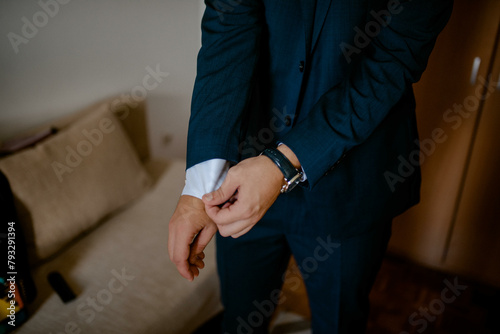 Guy is getting dressed for a business meeting.