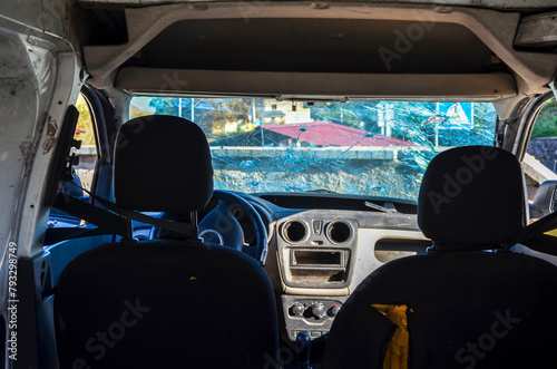 This image captures the interior of a car with a severely cracked windshield, illustrating the aftermath of an accident or impact, and highlighting the importance of safety measures