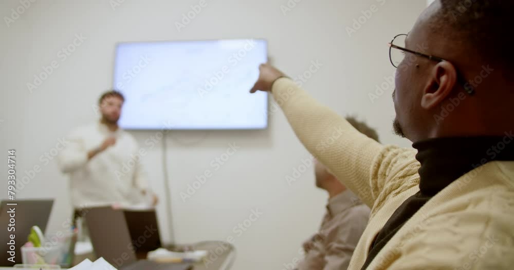 During a strategic business meeting, a business professional points to a growth chart displayed on a screen, illustrating key points and discussing strategic insights with colleagues. During a strategic business meeting, a business professional points to a growth chart displayed on a screen, illustrating key points and discussing strategic insights with colleagues.