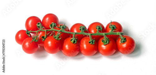 Fresh organic red cherry tomatoes on wine isolated on white background