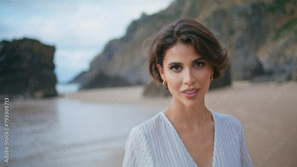 Portrait model posing coast on rocky island. Attractive calm woman walking beach Portrait model posing coast on rocky island. Attractive calm woman walking beach