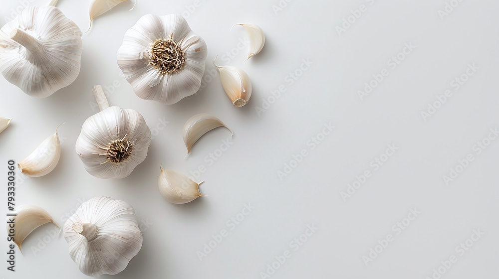 Garlics scattered on white background, flat lay, top view.