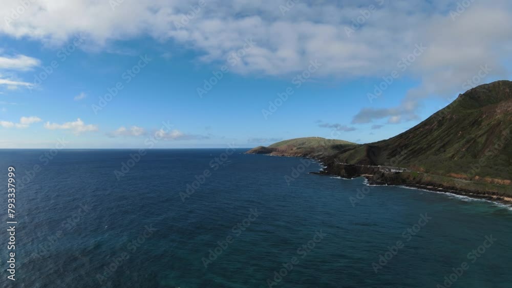 Drone aerial view of Halona Blowhole Lookout and Koko Crater in Hawaii, on a sunny day with lots of clouds. Drone aerial view of Halona Blowhole Lookout and Koko Crater in Hawaii, on a sunny day with lots of clouds.