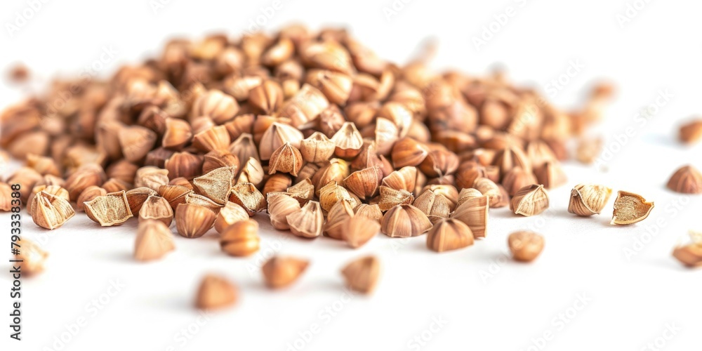A pile of nuts with some of them broken open. The nuts are scattered on a white background