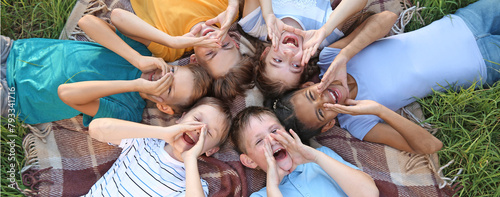 Group of children lying on plaid in park