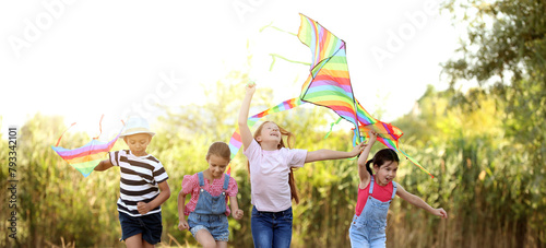 Little children flying kites outdoors