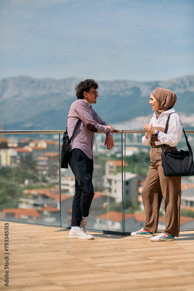 Obraz premium After a day at the office, a business man engages in conversation with his Muslim colleague wearing a hijab