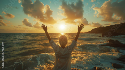 A senior woman raises her arms in a stretch by the sea at sunset, exuding joy and freedom.