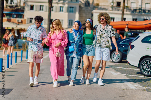 A diverse group of tourists, dressed in summer attire, strolls through the tourist city with wide smiles, enjoying their sightseeing adventure