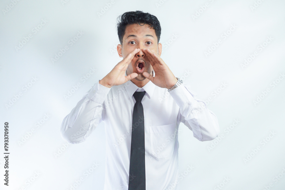 Young Asian man shouting to front with excited face expression Young Asian man shouting to front with excited face expression