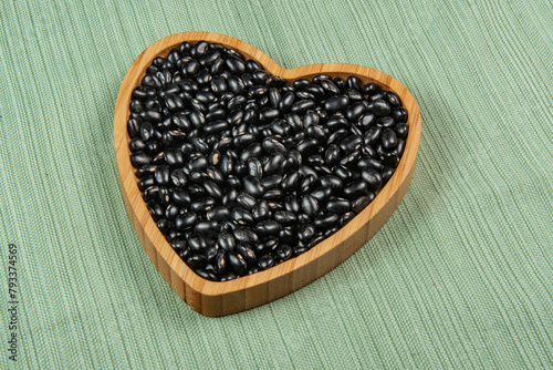 heart shaped black bean bowl on green tablecloth