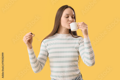 Young woman with CBD oil dr...