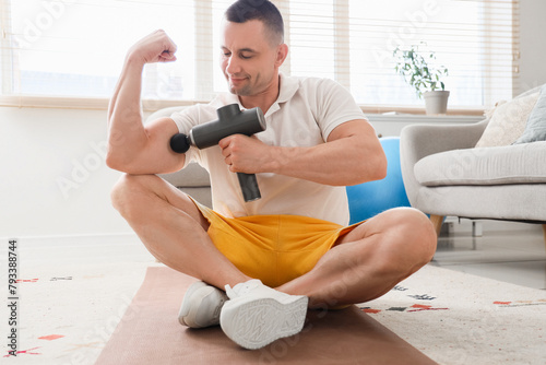 Sporty young man massaging ...