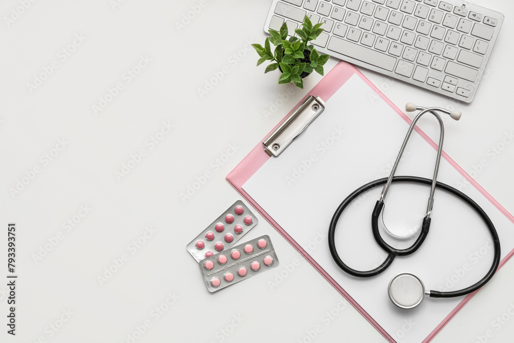Fototapeta premium Blank clipboard with stethoscope, pills and computer keyboard on white background. World Health Day