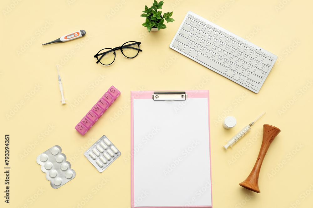 Blank clipboard with medical supplies and computer keyboard on yellow background. World Health Day Blank clipboard with medical supplies and computer keyboard on yellow background. World Health Day