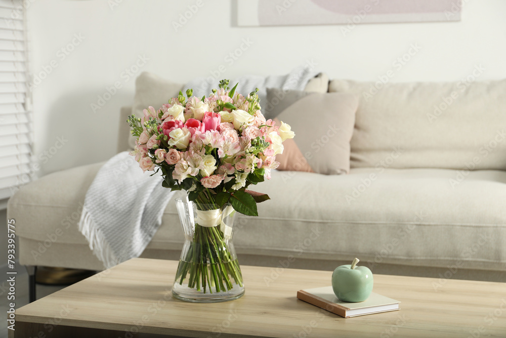 Beautiful bouquet of fresh flowers in vase on wooden table indoors Beautiful bouquet of fresh flowers in vase on wooden table indoors