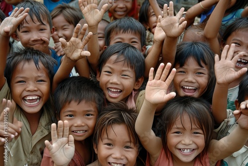 Group of happy asian children smiling and waving their hands in the air