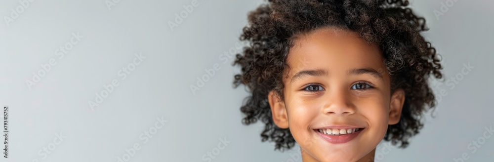 Cheerful Child with Curly Hair and a Happy Smile - Youthful Innocence and Joy on Light Background, Copy Space Cheerful Child with Curly Hair and a Happy Smile - Youthful Innocence and Joy on Light Background, Copy Space