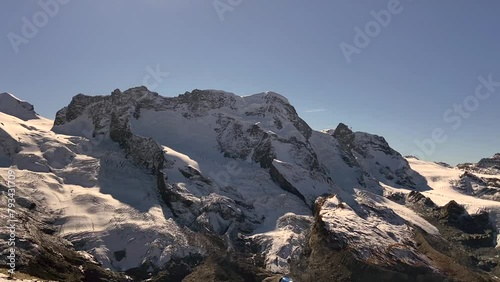 The snowy peaks of Switzerland. Mount Zermat in the sunlight from the observation deck. photo