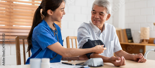 Asian caregiver doctor examine older patient use blood pressure gauge. 