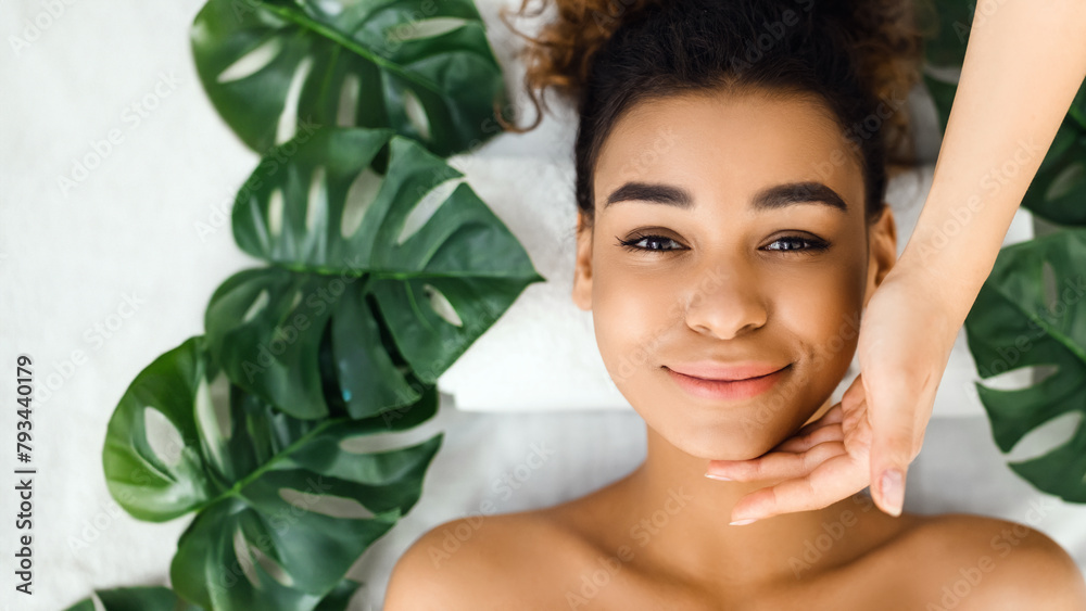 Woman smiling with hands framing face, view above Woman smiling with hands framing face, view above