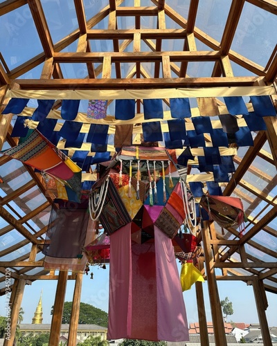Colorful prayer flags hanging on the roof of the temple in Thailand