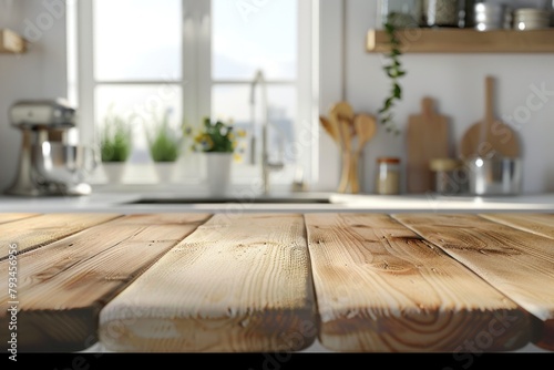 Wooden kitchen table in sharp focus with a sunlit kitchen and plants in the blurred background.