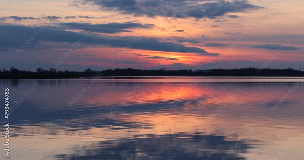 reflection of the sky in the lake during sunset, winter sunset on the lake after the ice melts reflection of the sky in the lake during sunset, winter sunset on the lake after the ice melts
