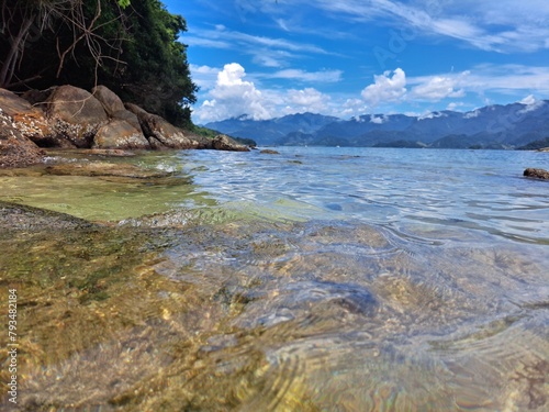 Wallpaper Mural Pelado Island in Paraty, mountains in the background,sky with clouds, large rocks, and calm sea. Natural swimming pool and warm water Torontodigital.ca