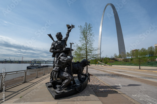 Monument to Lewis and Clarke expedition on Mississippi River with Gateway Arch National Park in Saint Louis, Missouri in background.