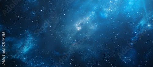 A detailed view of a mesmerizing blue galaxy filled with twinkling stars set against a deep black background photo