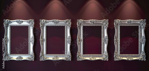 Four decorative empty frames with silver leaf detailing on a rich burgundy wall, each frame lit by soft gallery lighting photo