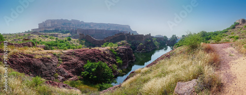 Panoramic view of Mehrangarh fort from Rao Jodha desert rock park, Jodhpur, India. A lake in foreground and Mehrangarh fort in the background, with rocky landscape of the desert park. photo