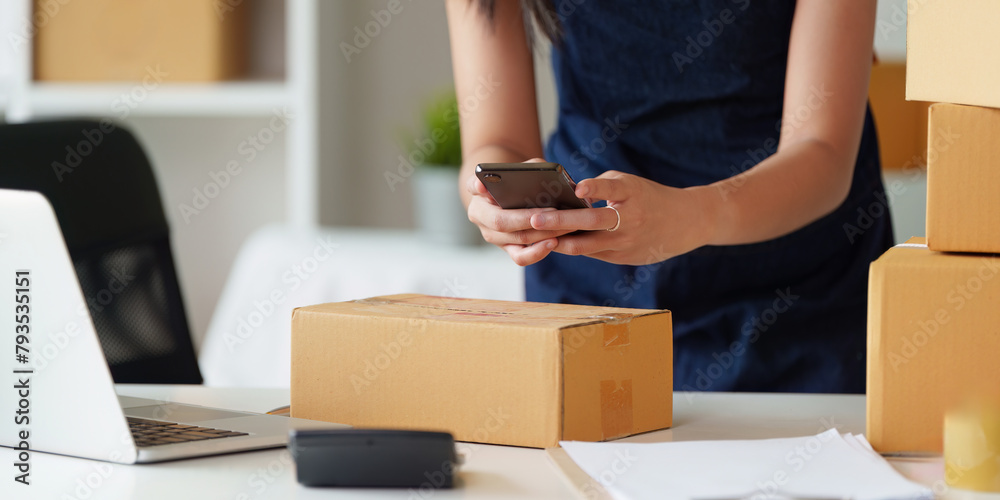 Close up woman entrepreneur working at home office and taking a parcel photo before delivery Close up woman entrepreneur working at home office and taking a parcel photo before delivery