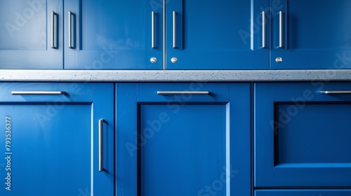 A market-style showcase of blue kitchen cabinet doors, adorned with contemporary stainless steel handles