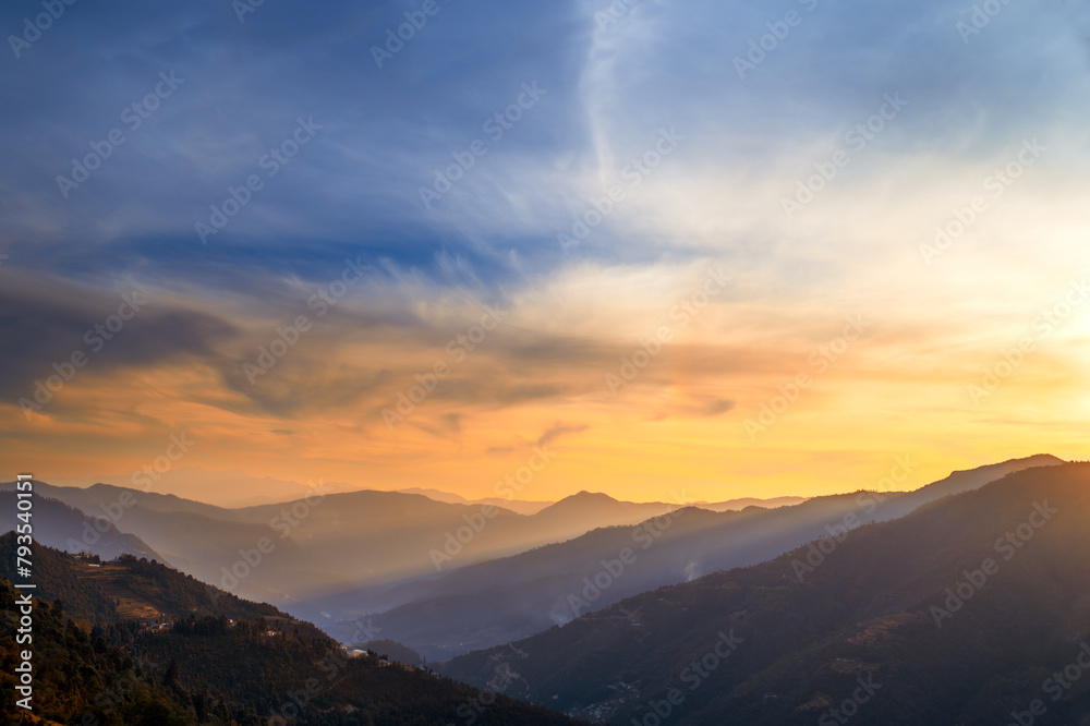 Sunset over the mountains. Majestic panoramic view of the Himalayan range in the Kumaun region of Uttarakhand, India. 